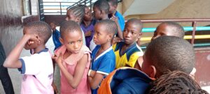 Pupils waiting to be measured for shoes and uniforms in Bariga, Lagos
